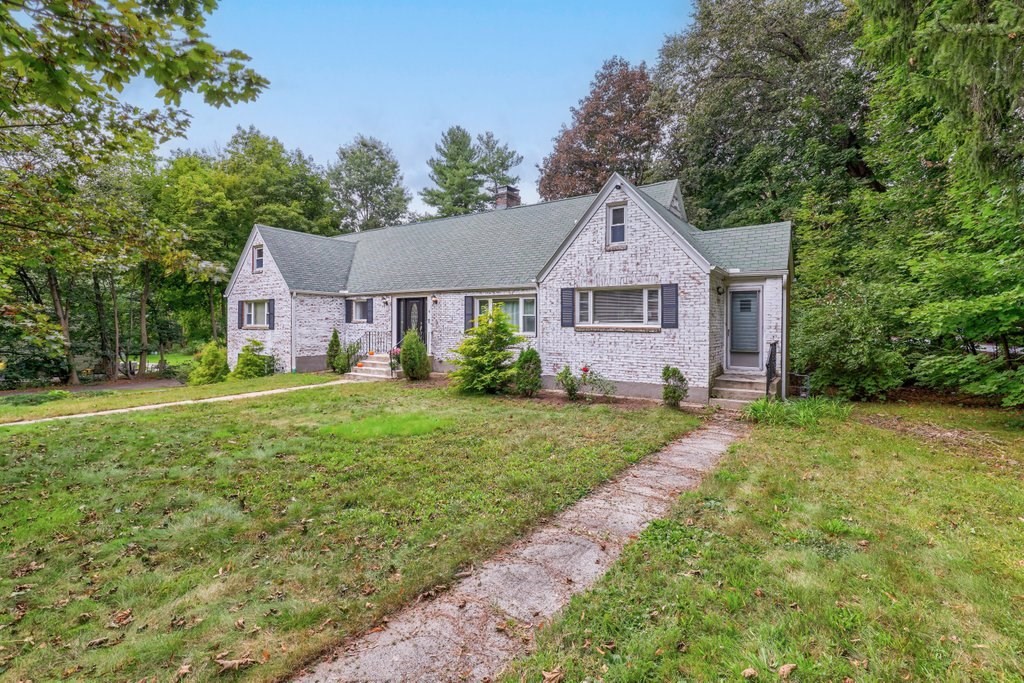4 Ellis Drive Worcester, MA 01609 - Photo 4 of 32 a front view of a house with a yard and trees