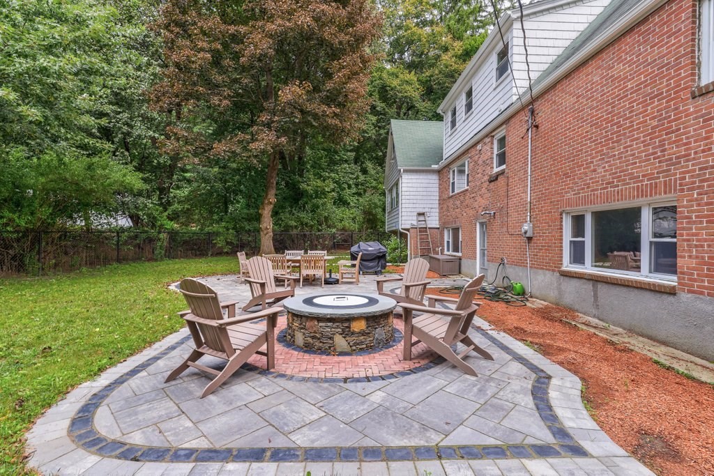 4 Ellis Drive Worcester, MA 01609 - Photo 7 of 32 a view of a patio with table and chairs potted plants with wooden floor and fence