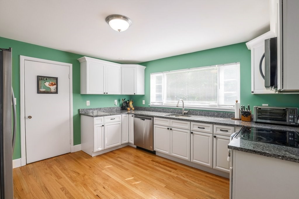 4 Ellis Drive Worcester, MA 01609 - Photo 9 of 32 a kitchen with granite countertop a sink stainless steel appliances white cabinets and a window