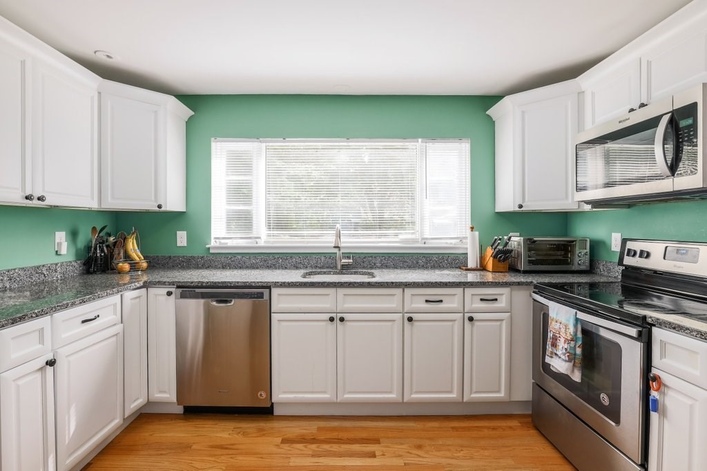 4 Ellis Drive Worcester, MA 01609 - Photo 10 of 32 a kitchen with granite countertop a sink stainless steel appliances white cabinets and a window