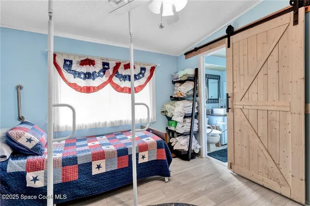 a bedroom with lots of different colored cloths