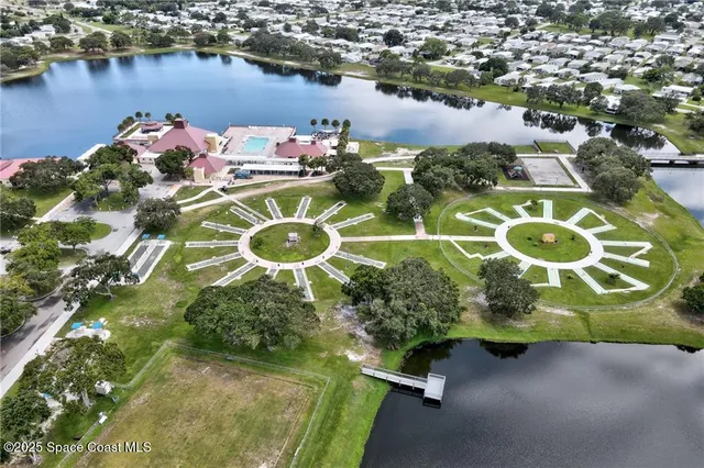 an aerial view of a house with a lake view