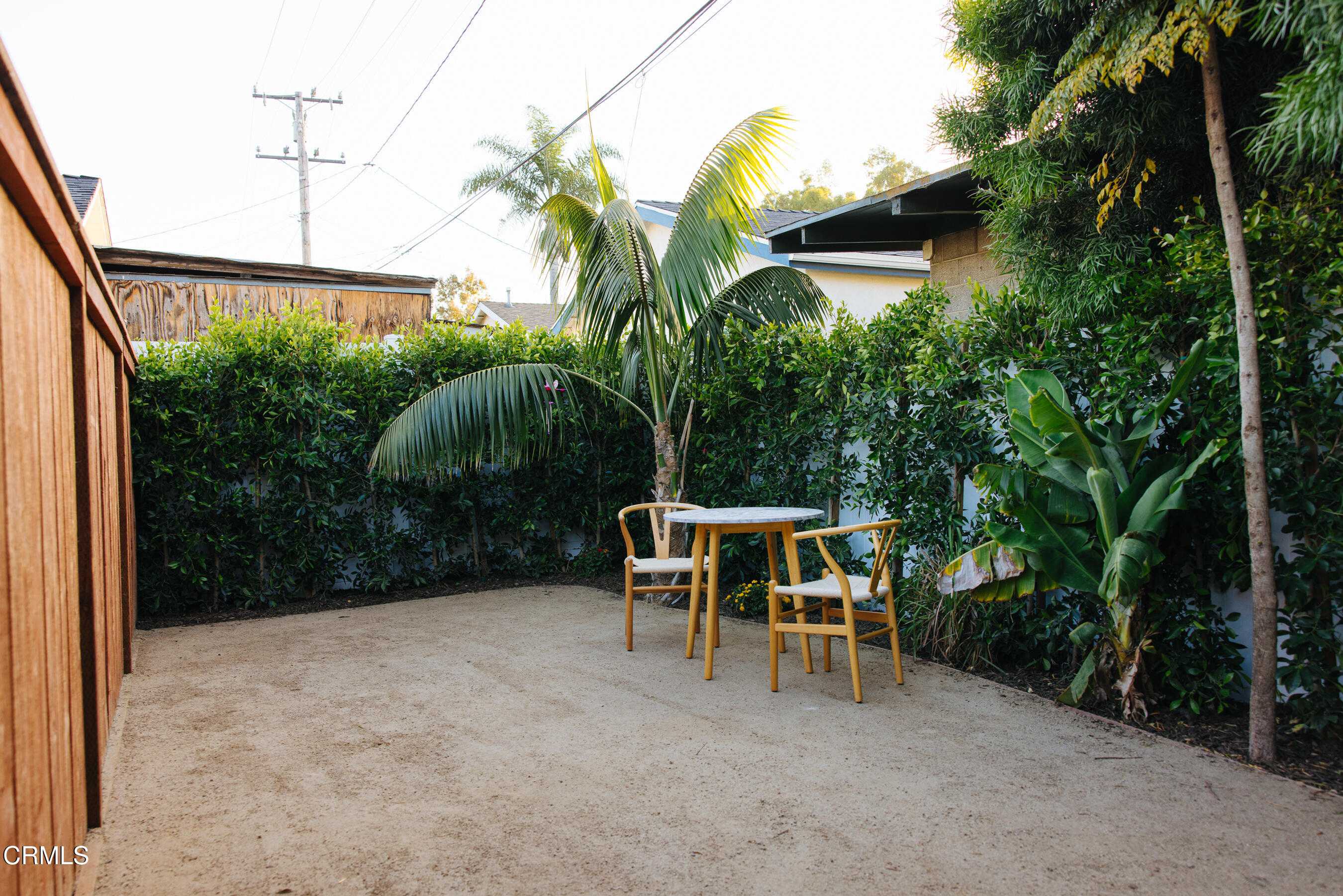152 Arcade Drive Ventura, CA 93003 - Photo 24 of 25 a view of backyard with a table and chairs and potted plants