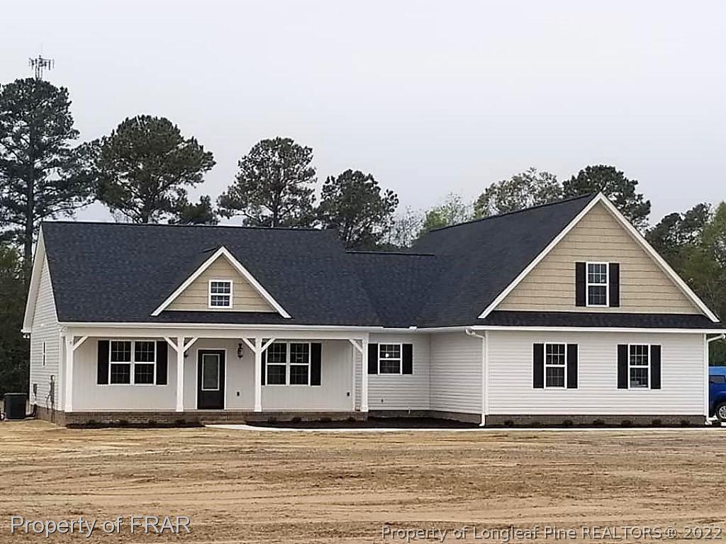 2945 Hayfield Road Wade, NC 28395 - Photo 1 of 26 a front view of a house with a garden