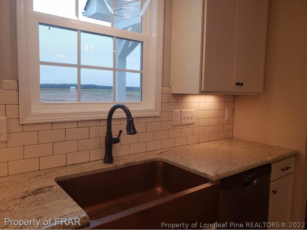 2945 Hayfield Road Wade, NC 28395 - Photo 16 of 26 a bathroom with a sink and a window