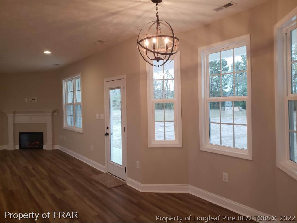 2945 Hayfield Road Wade, NC 28395 - Photo 19 of 26 a view of livingroom window and wooden floor