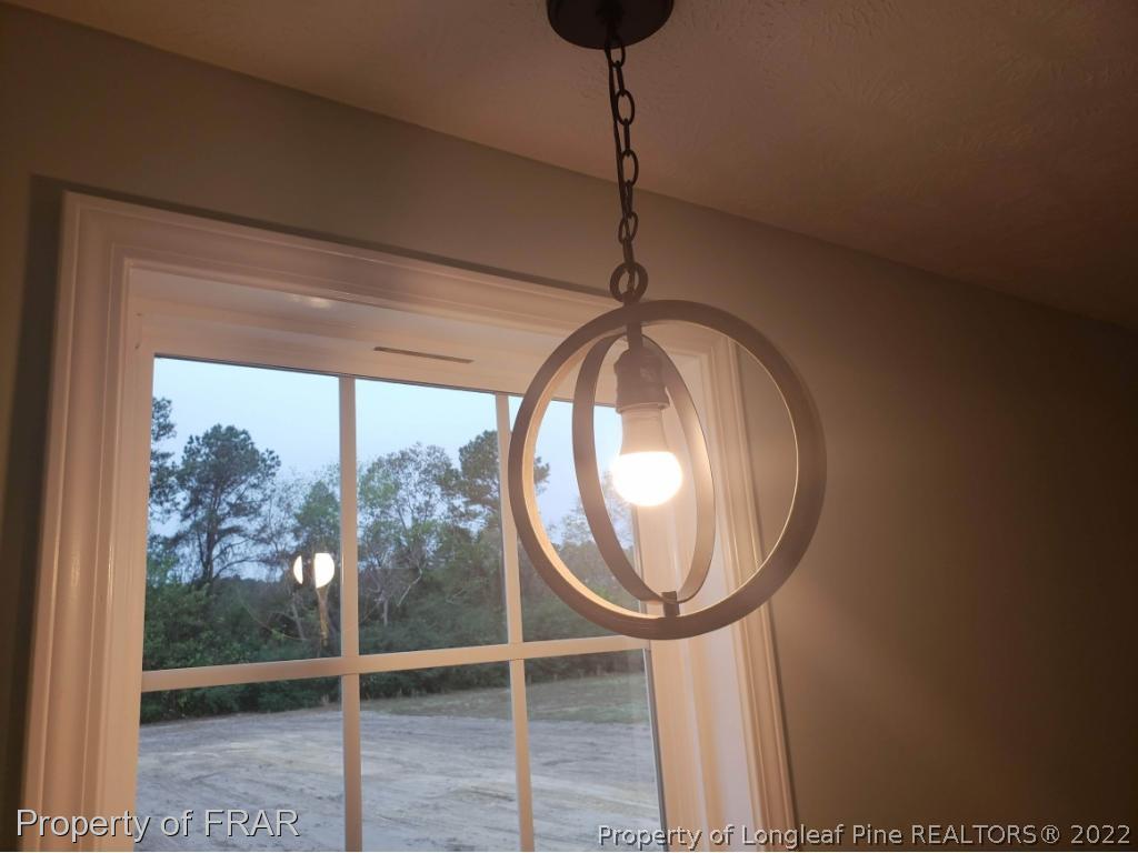 2945 Hayfield Road Wade, NC 28395 - Photo 20 of 26 a view of a livingroom with furniture and chandelier
