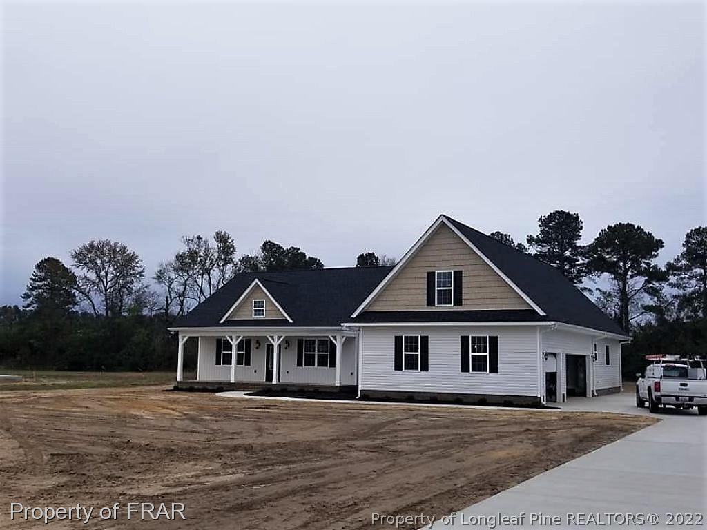 2945 Hayfield Road Wade, NC 28395 - Photo 26 of 26 a house with trees in the background