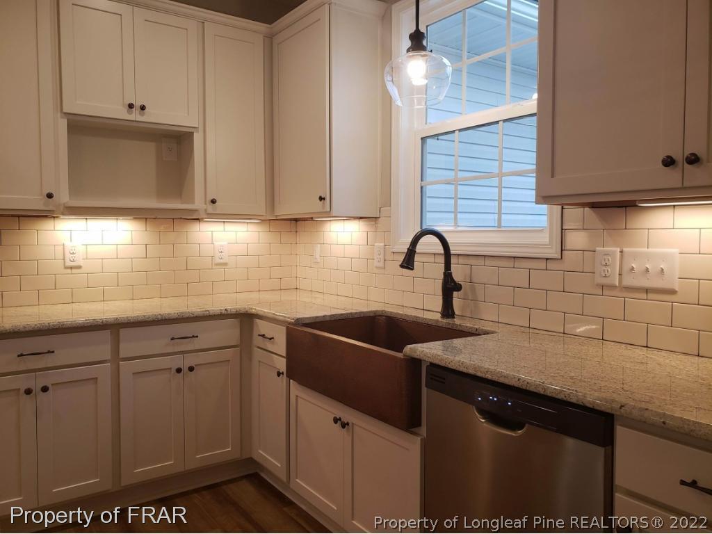 2945 Hayfield Road Wade, NC 28395 - Photo 3 of 26 a kitchen with sink cabinets and window