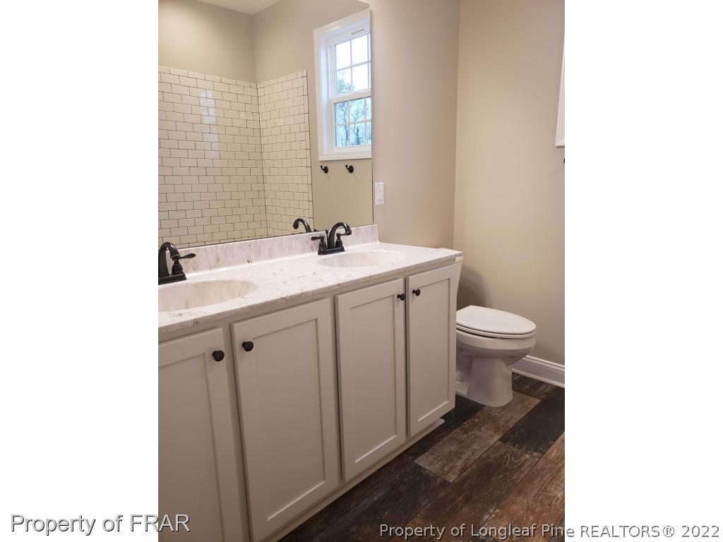 2945 Hayfield Road Wade, NC 28395 - Photo 9 of 26 a bathroom with a sink toilet and mirror
