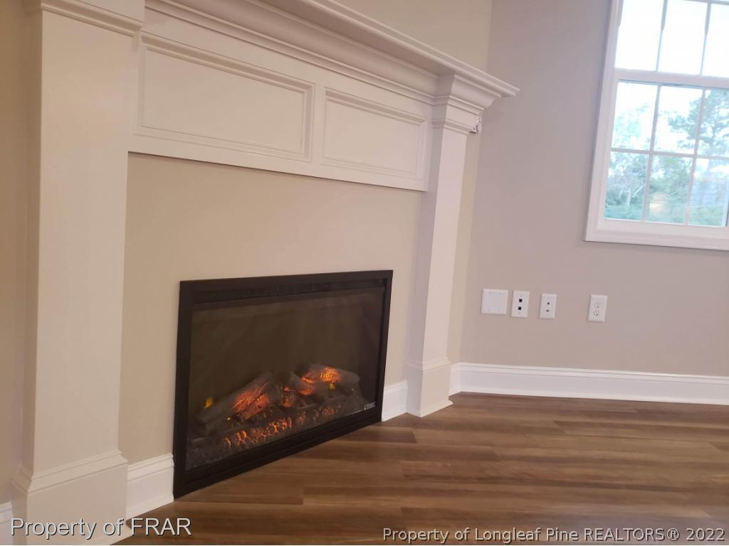 2945 Hayfield Road Wade, NC 28395 - Photo 10 of 26 a view of fireplace room with wooden floor and a window