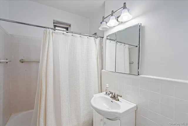 a kitchen with stainless steel appliances a sink a stove a refrigerator cabinets and a window