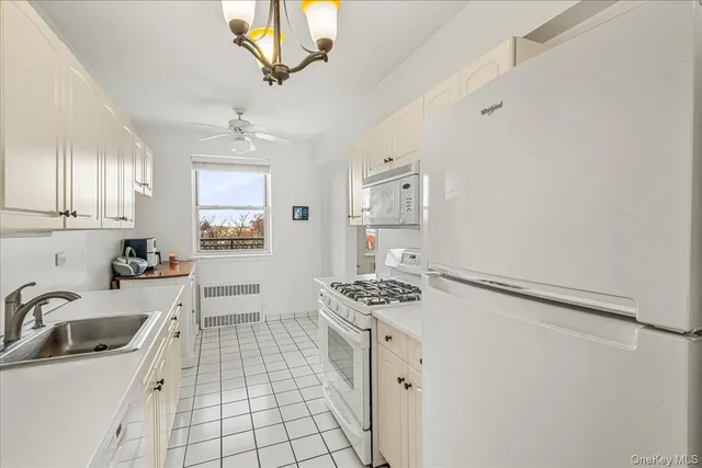 a kitchen with a sink cabinets and window