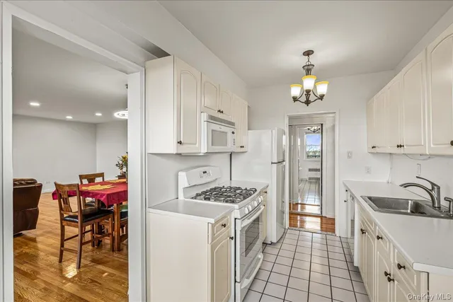 a utility room with dryer washer and racks
