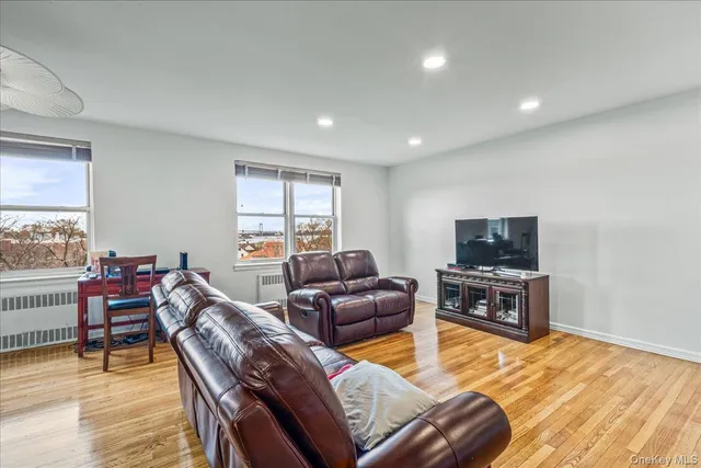 a living room with furniture window and wooden floor