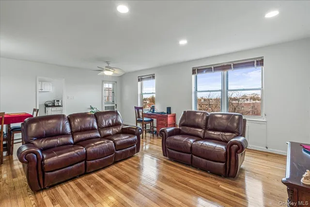 a living room with furniture a dining table and a potted plant
