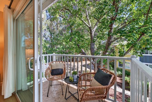a view of balcony with a potted plant and outdoor seating