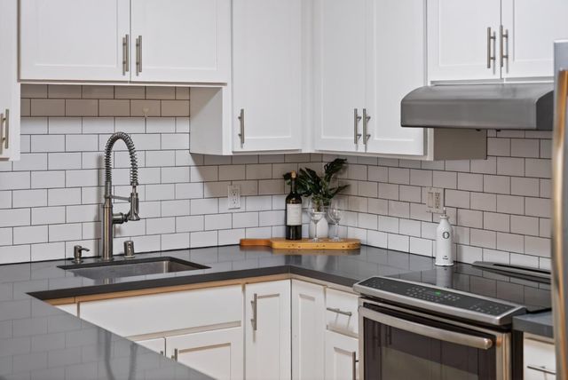 a kitchen with a sink and cabinets