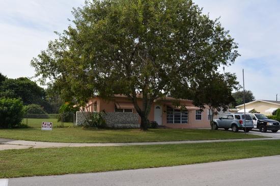 301 Winged Foot Road Palm Springs, FL 33461 - Photo 1 of 1 a front view of a house with a garden