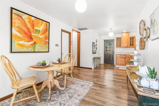 a dining room with furniture and wooden floor