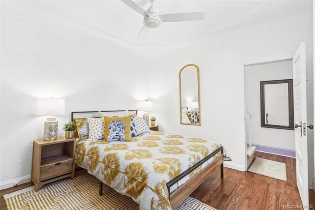 a bedroom with a bed and a wooden floor