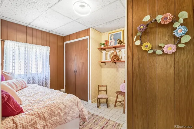 a bedroom with a bed dresser and window