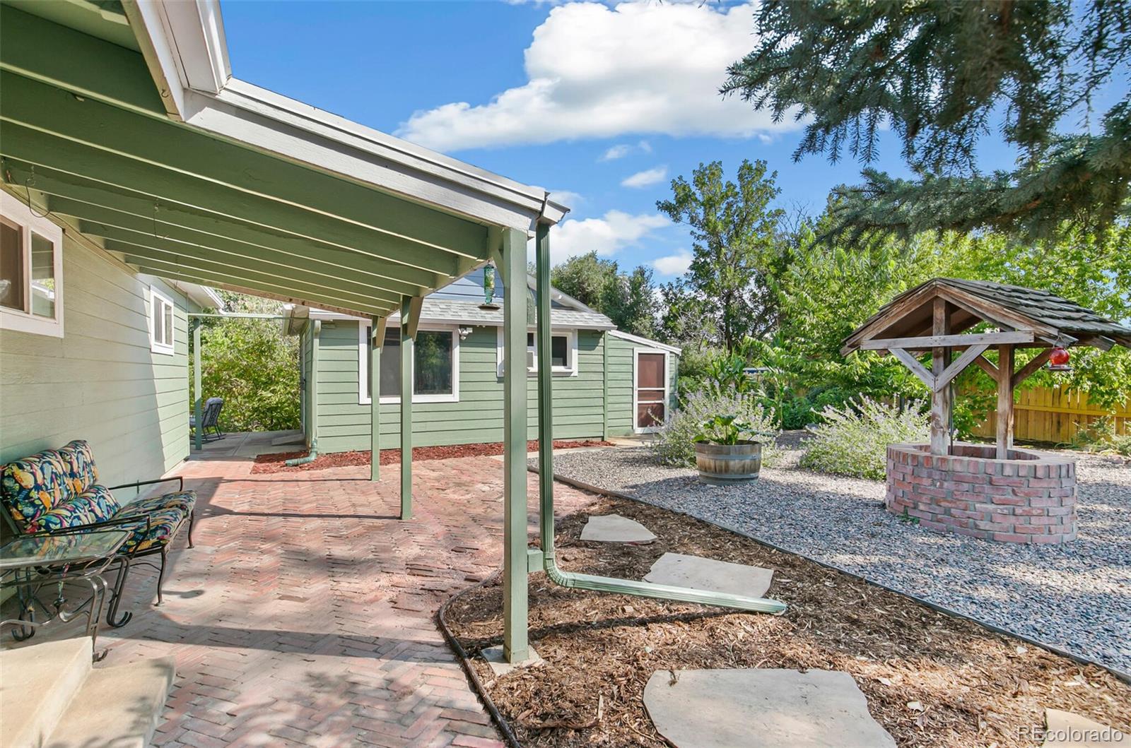 7221 West 48th Avenue Wheat Ridge, CO 80033 - Photo 34 of 42 a view of a house with backyard and sitting area