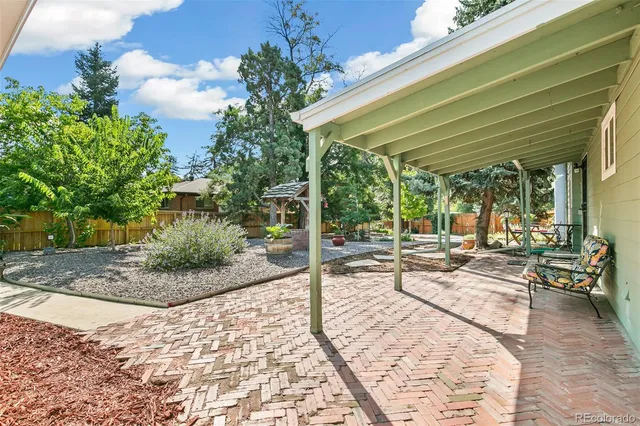 a view of a backyard with sitting area