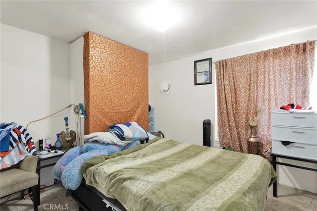 a bedroom with a bed and a window