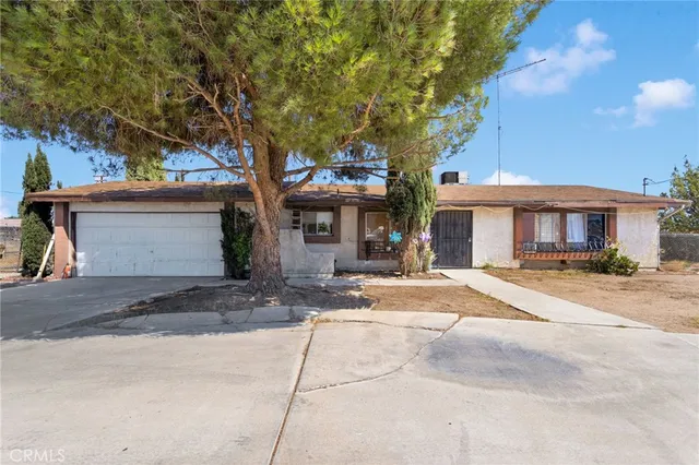 a front view of a house with a yard and a garage