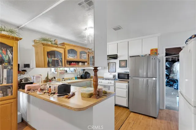 a kitchen with a sink a refrigerator and a stove