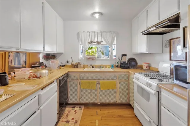 a kitchen with a sink cabinets and window