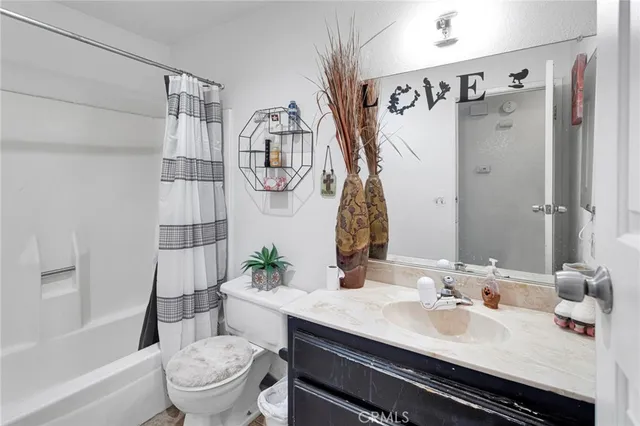 a bathroom with a sink toilet tub and shower