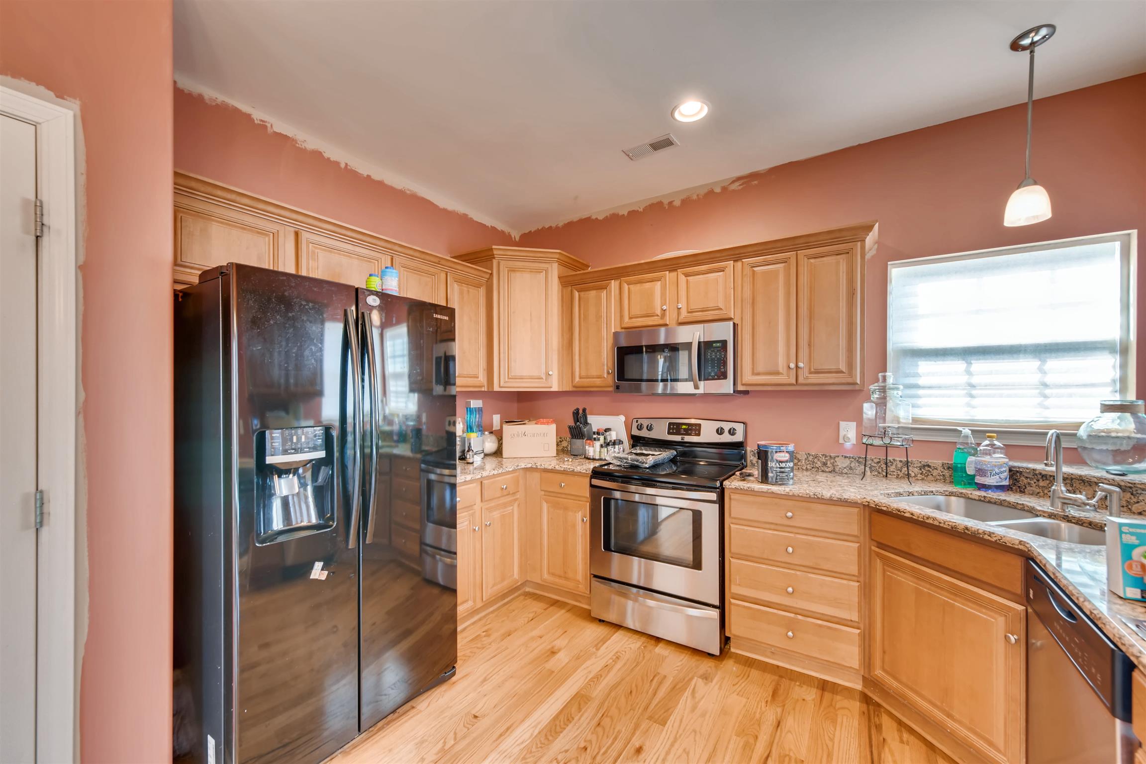 1054 Golf View Way Spring Hill, TN 37174 - Photo 6 of 16 a kitchen with stainless steel appliances granite countertop a refrigerator stove microwave and sink