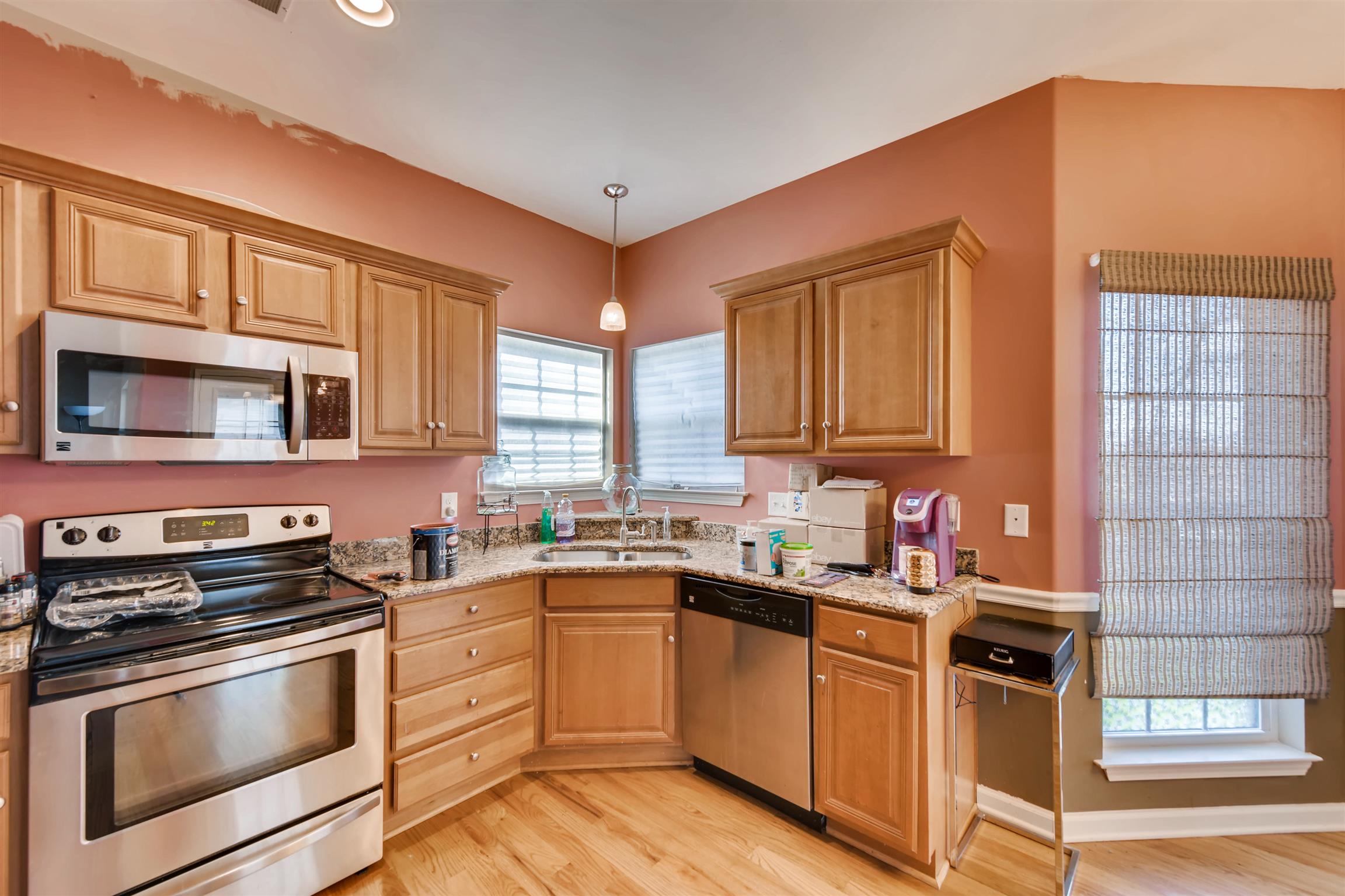 1054 Golf View Way Spring Hill, TN 37174 - Photo 7 of 16 a kitchen with a sink stove top oven and cabinets