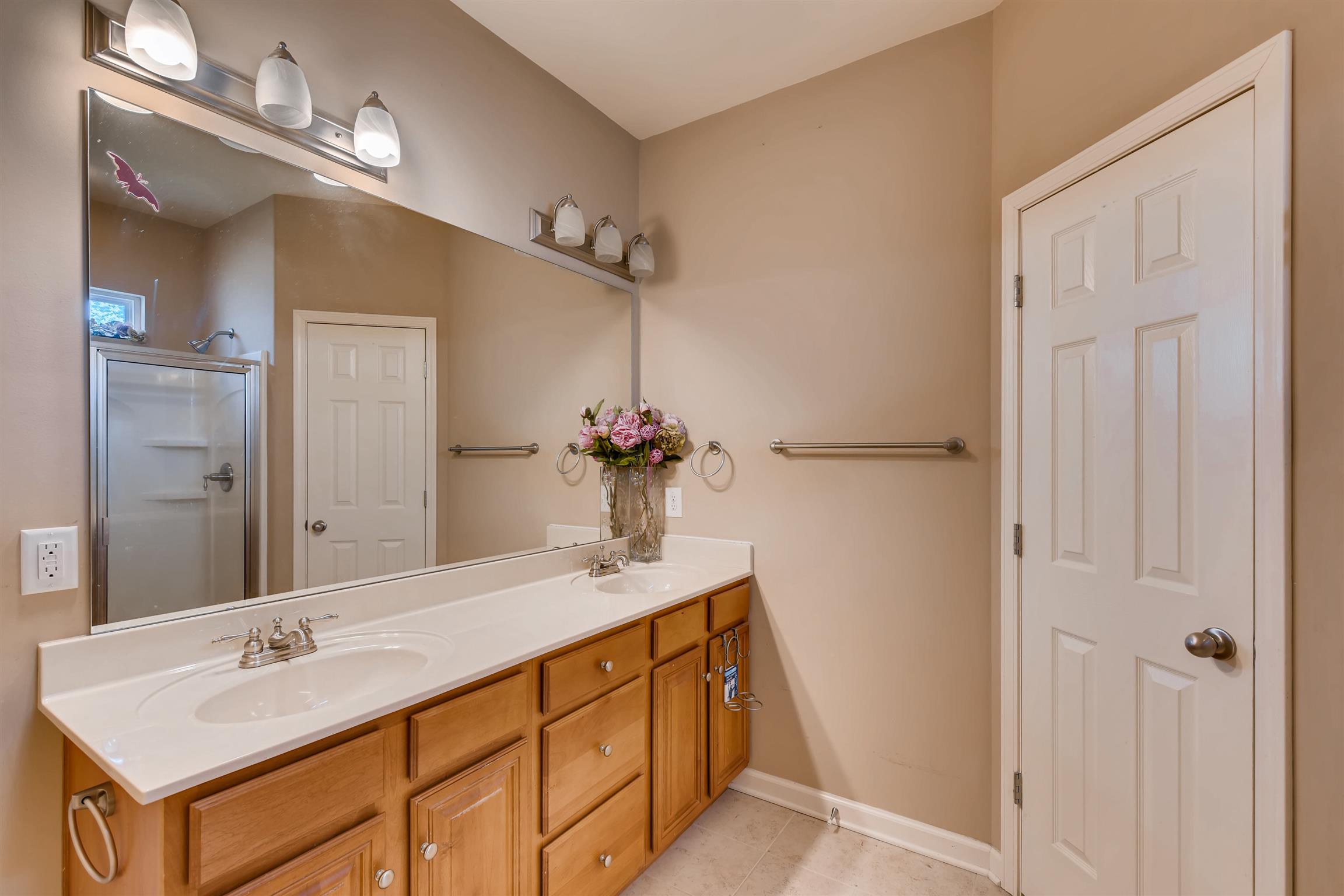 1054 Golf View Way Spring Hill, TN 37174 - Photo 10 of 16 a bathroom with a sink and a mirror