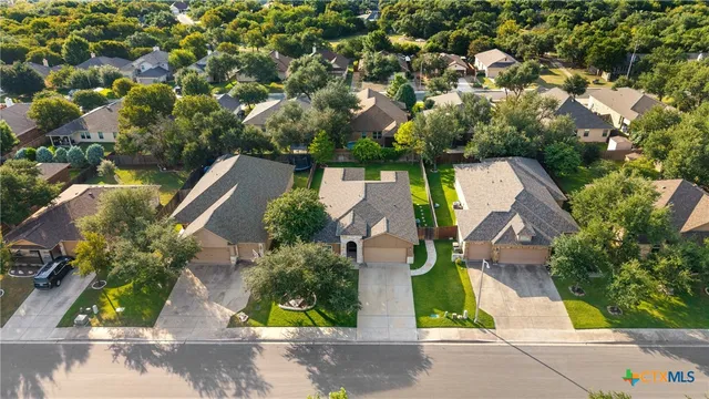an aerial view of a house with garden space and street view