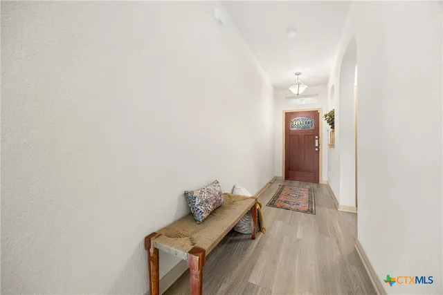 a hallway with table and couch