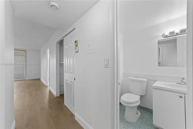 a white toilet sitting next to a bathroom sink