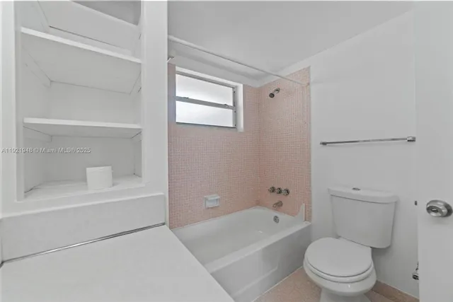 a bathroom with a toilet and a bathtub