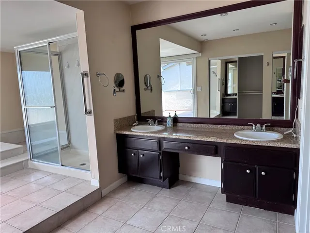 a spacious bathroom with a tub and a shower