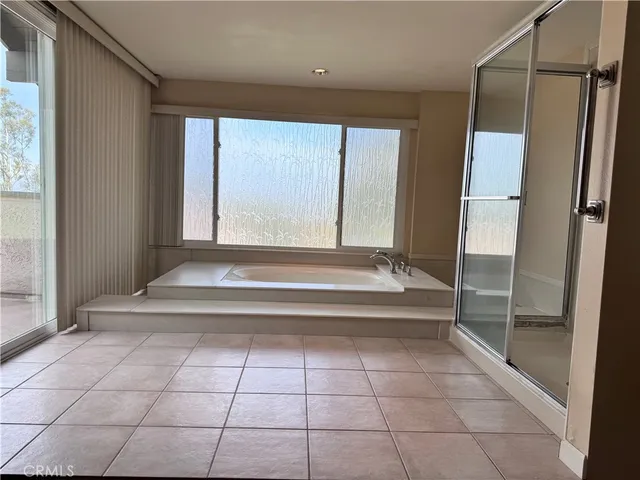 a bathroom with a tub and shower