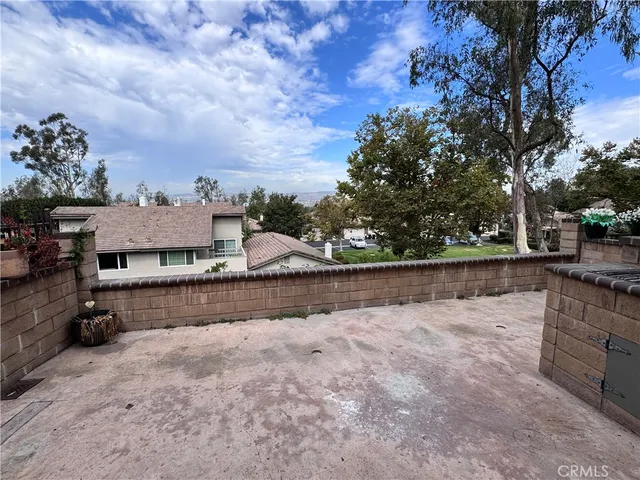 a view of a house with a wooden fence