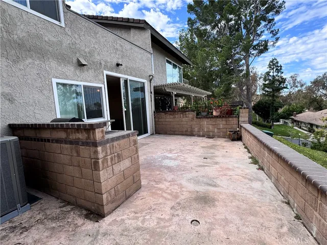 a view of a patio with table and chairs potted plants with wooden fence