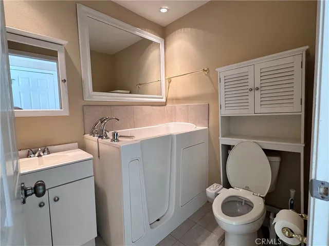 a view of a room with wooden floor and a glass door