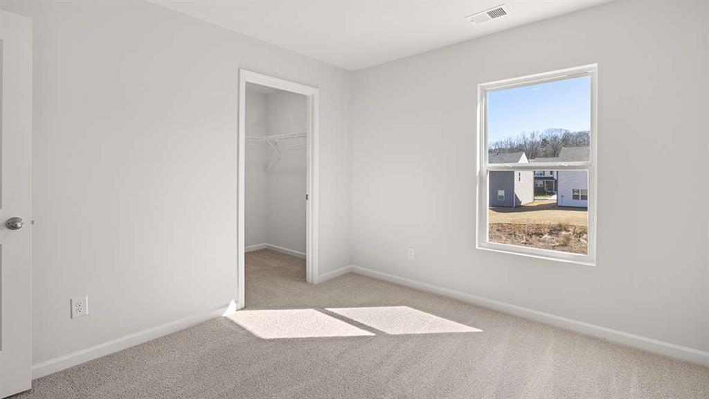 6068 Knickerbocker Street Mableton, GA 30126 - Photo 15 of 15 an empty room with windows and closet