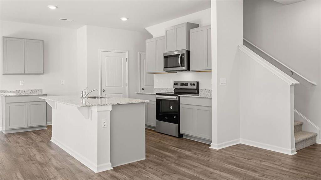 6068 Knickerbocker Street Mableton, GA 30126 - Photo 3 of 15 a kitchen with white cabinets and appliances