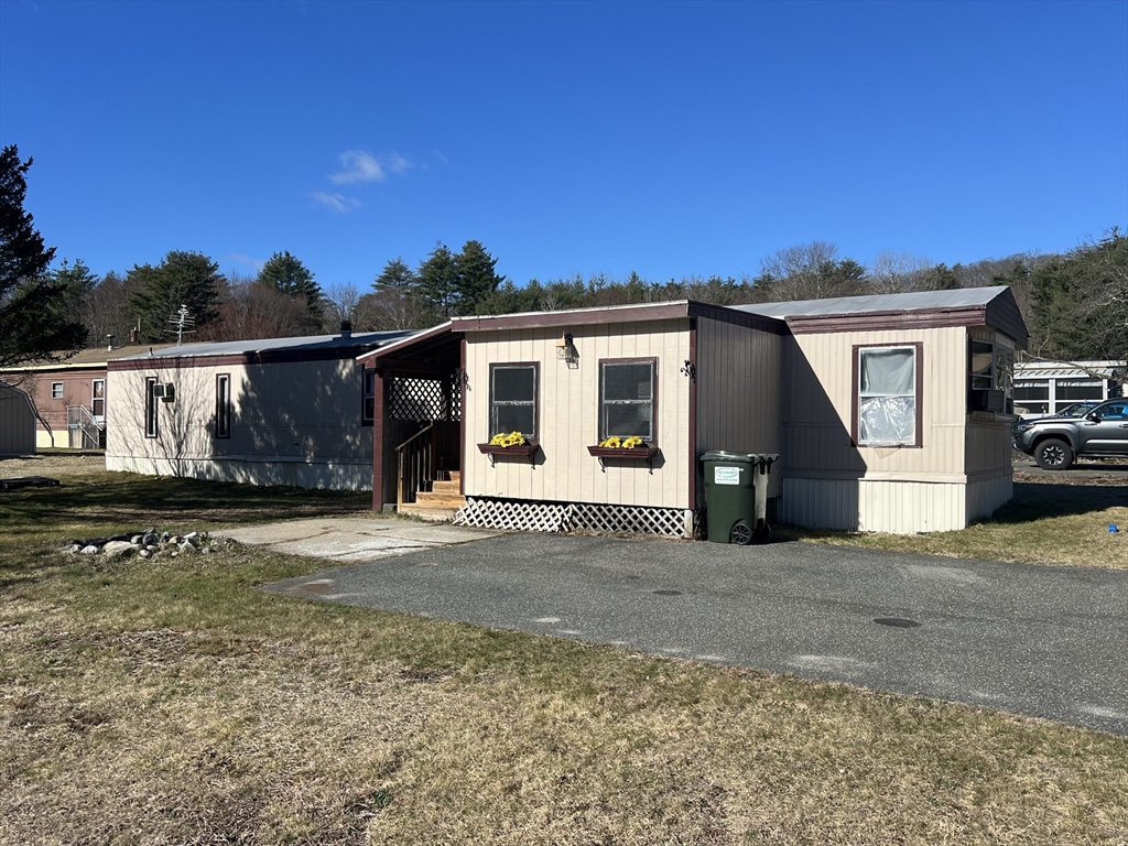 51 Monson Turnpike Road, Unit 1042 Ware, MA 01082 - Photo 1 of 14 a front view of a house with a yard