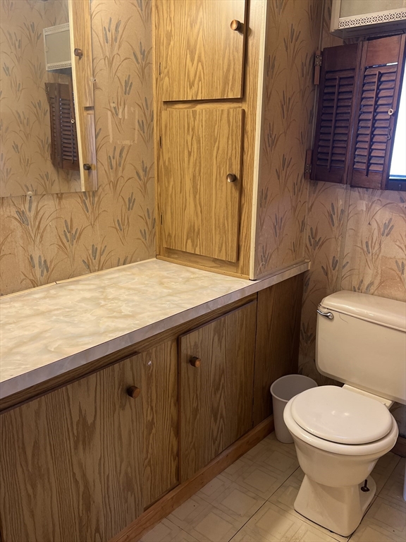 51 Monson Turnpike Road, Unit 1042 Ware, MA 01082 - Photo 12 of 14 a bathroom with a granite countertop toilet and a sink