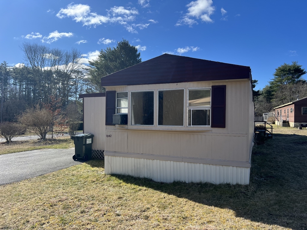 51 Monson Turnpike Road, Unit 1042 Ware, MA 01082 - Photo 3 of 14 a front view of a house with a yard